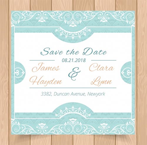 การ์ด Save the Date สีฟ้ามิ้นต์สดใส ตกแต่งด้วยลวดลายวินเทจสีขาวหรูหรา วางบนพื้นหลังลายไม้ ระบุชื่อ James Hayden และ Clara Lynn